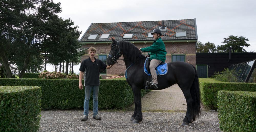 The Dutch farrier Douwe Dokter with a Frisian Horse
