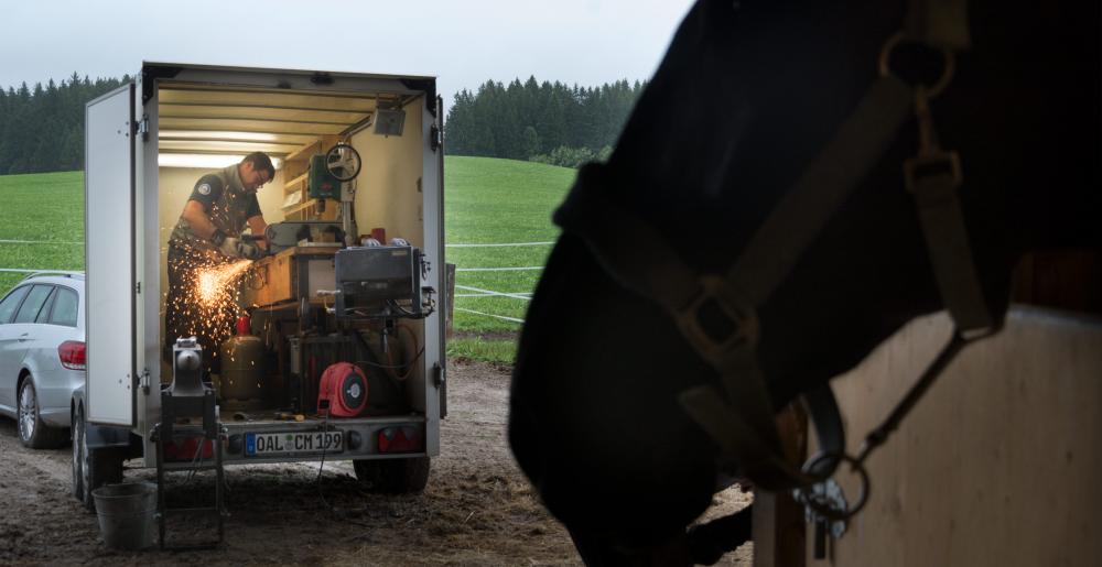 The German farrier Christoph Müller at work in his trailer